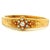 A beautifully crafted vintage hinged bangle bracelet in solid 14 karat yellow gold, featuring a sparkling round brilliant-...