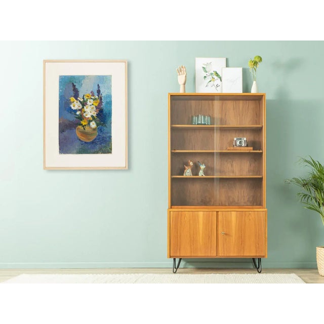 Bouquet of hyacinths and margins against blue background in expressionist style. oil on panel from the 1950s. The picture...