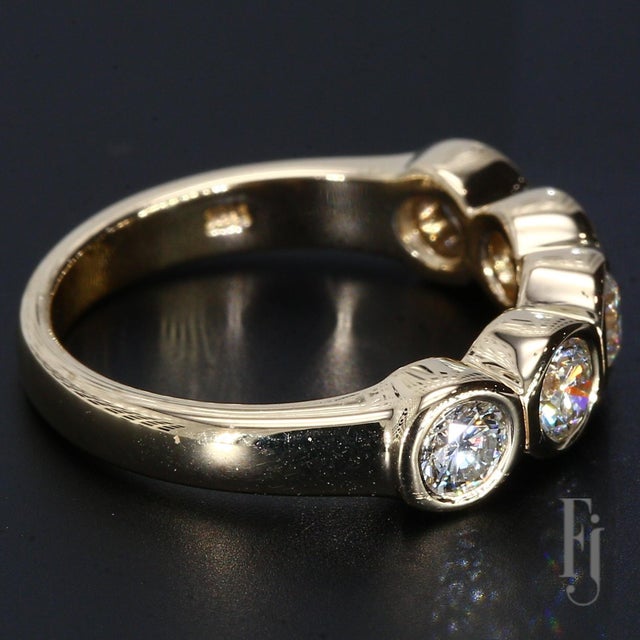 A 14k Yellow Gold Ring with Five Bezel Set Diamonds Each Weighing ~0.25ct. The Diamonds are Graded VVS2/F. Size - 5.25...