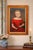 This antique oil painting is a striking portrait of a figure dressed in an opulent red gown adorned with delicate white...