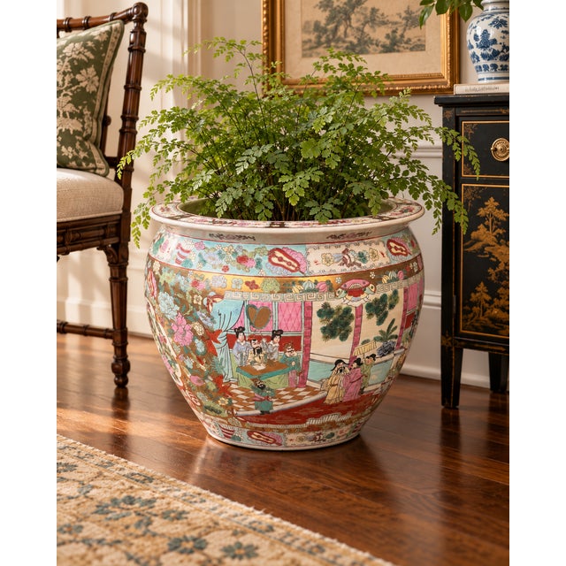 A beautifully decorated Chinese famille rose porcelain fishbowl planter featuring an elaborate composition of traditional...