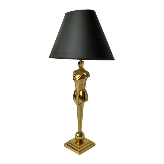 A statement piece, for sure, this modern torso-form lamp is made of heavy brass and includes its original black paper...