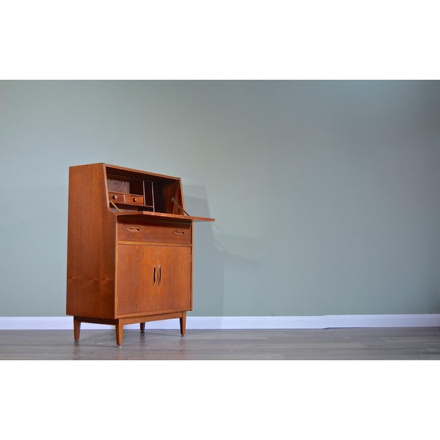 Mid-Century Teak Secretary from Jentique, 1960s, in Very Good conditions. Designed 1960 to 1969 This piece has an...