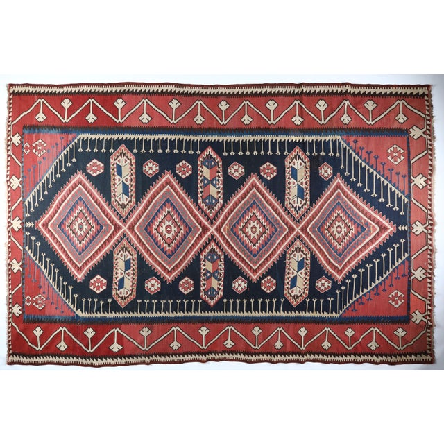 This exquisite handwoven Shirvan kilim from the Caucasus reflects the masterful craftsmanship of the late 19th to early...