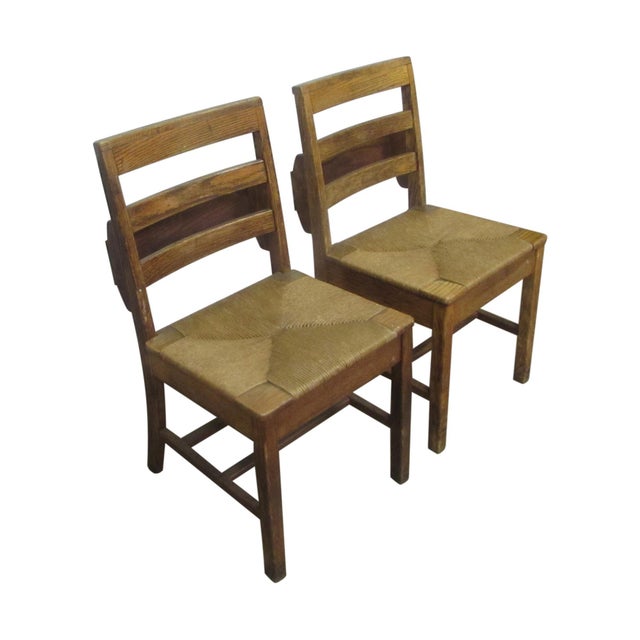 Set of square wooden chairs with hand caned seats. The back have three squared off wooden pane supports and a square seat....