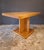 Elegant dining table with a central leg, crafted from ash wood in the 1950s. The table is highly sought-after, starting...