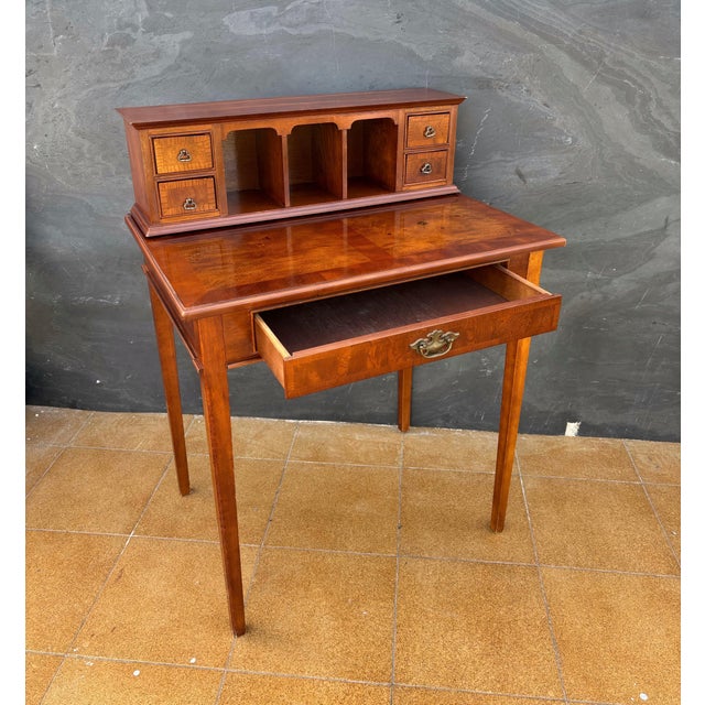 Elegant Louis XVI-style writing desk dating to the Mid-20th century. The desk features a rectangular writing surface above...