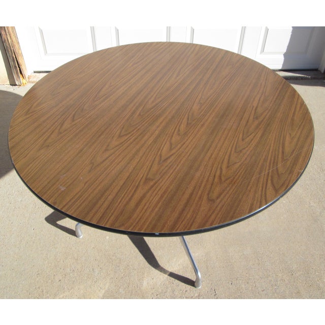 Vintage Mid Century Modern Herman Miller Aluminum Group Round Table with a dark brown Formica wood grain top with black...