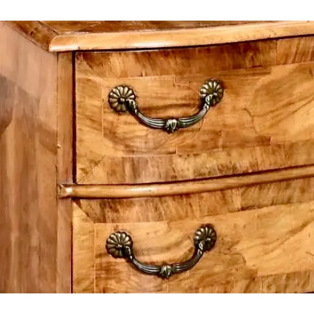 This is a good example of a Continental or South German serpentine-front inlaid walnut and Circassian walnut chest of...