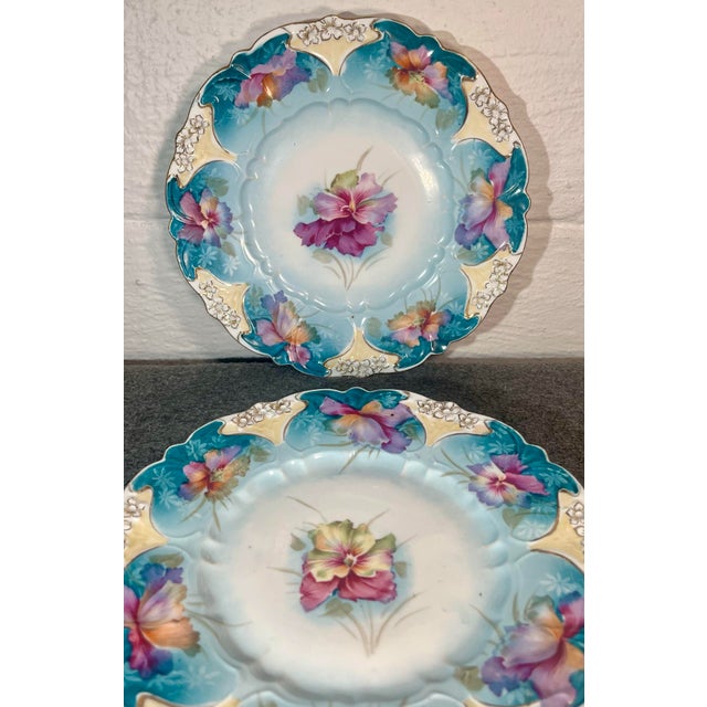 2-Scalloped and embossed finely detailed hand painted porcelain plates. Floral scenes with soothing colors of blues,...