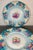 2-Scalloped and embossed finely detailed hand painted porcelain plates. Floral scenes with soothing colors of blues,...