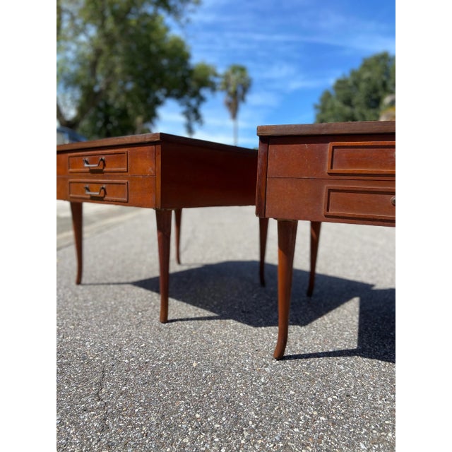 Pair of American of Martinsville Nightstands. One shapely box style with curved Tapered legs makes for a juxtaposed...
