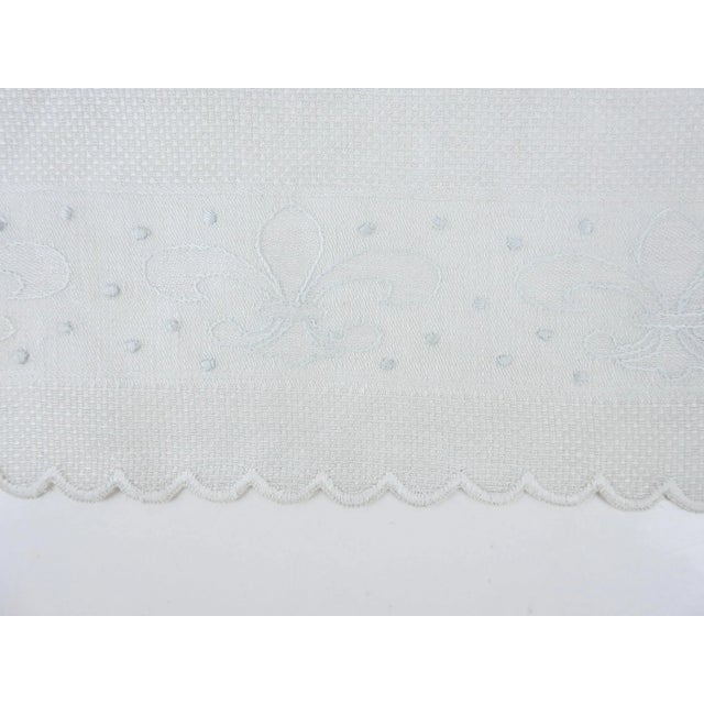 Vintage damask linen tea or hand towel. Fluer de lis damask pattern which has been highlighted with ice blue embroidery on...