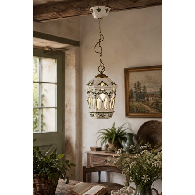 Charming vintage ceramic pendant light featuring hand-painted green birds and botanical motifs on a warm white ground. The...