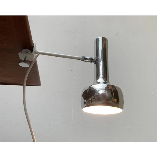 Minimalist clamping lights from Swisslamps. A simple and restrained design. The luminaire head shows a radiator shape with...