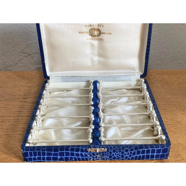 Set of 12 vintage silver-plated metal knife rests, cross/ball design Each piece is hallmarked SFAM (silversmith's mark)...