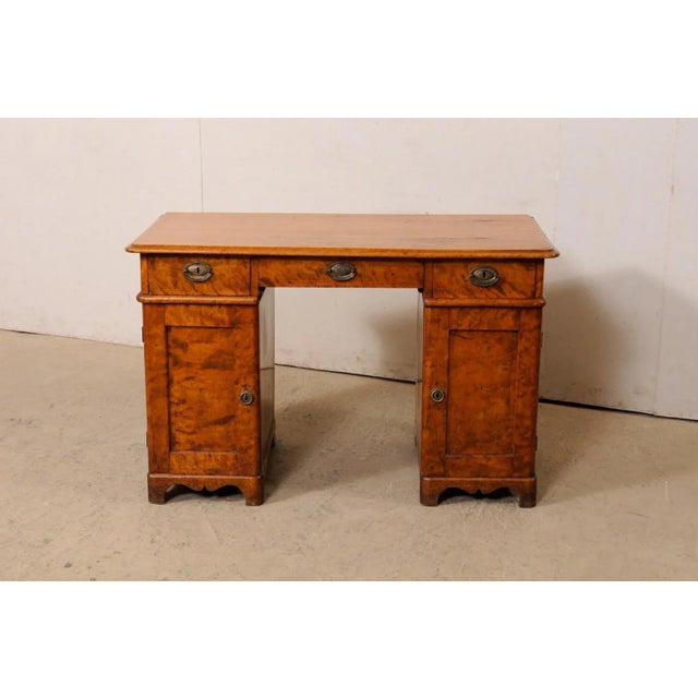 A Swedish pedestal curly birch desk, circa 1820-40. This antique desk from Sweden features a four foot long, rectangular-...
