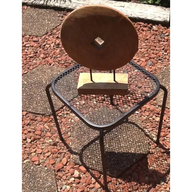 This Danish Modern inspired tabletop sculpture is a natural carved wood pulley wheel supported by 2 black metal rods...