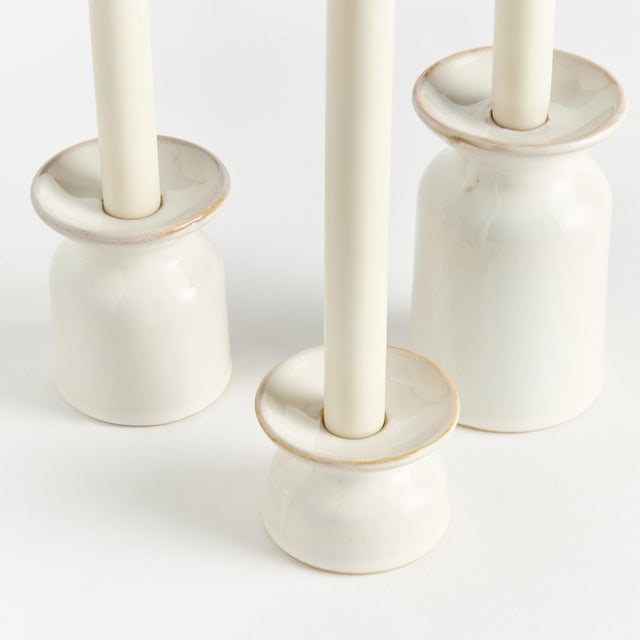 Made of a highfired, durable stoneware and finished with aCreamyWhite reactive glaze, the Owen Candle Stands are a...