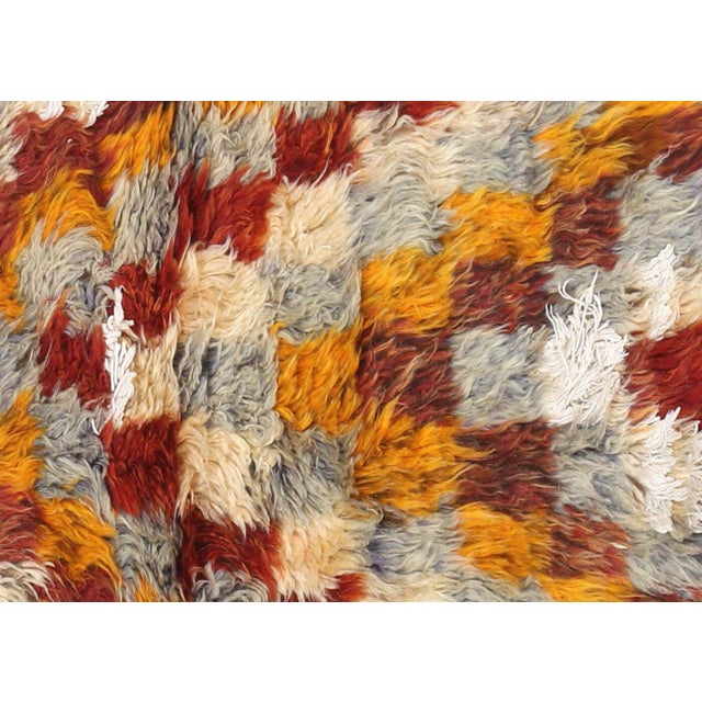 This vintage Turkish Tulu rug, measuring 3'1" x 5'9", is handwoven with soft Angora wool on a wool kilim foundation in the...