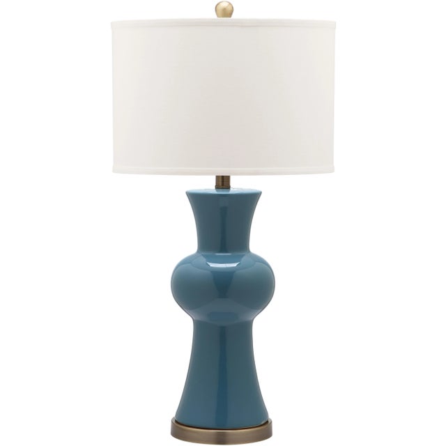 Perk up any room in the house with the young but sophisticated column lamp. With vivid orange ceramic hourglass base...