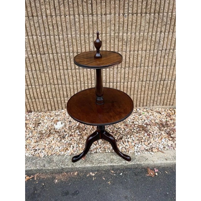 Antique George III Style Walnut Two Tier Dumbwaiter Features two graduated circular tiers, Queen Anne style Circa early...