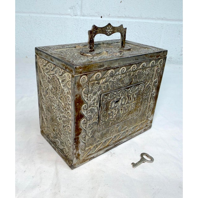The large antique J.E. Stevens cast iron still safe with its original key is a unique and collectible piece of bank...