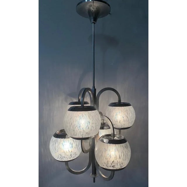 Beautiful chandelier with 6 lights of about 1960. the structure of the chandelier is in metal. it was totally clean. it...