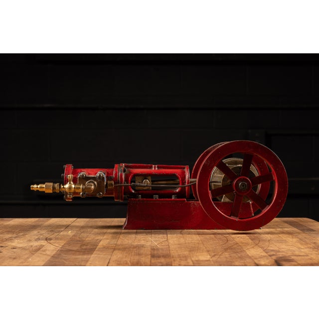 A finely made foundry or apprentice demonstration small-scale horizontal steam engine featuring a cast iron frame finished...