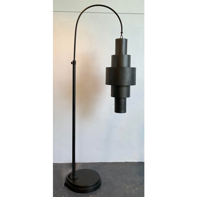 This monumental arc floor lamp by Global Views is a masterclass in architectural lighting, perfect for the collector...