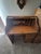 Often referred to as a children's roll top desk, this antique operates on an S-roll, single pedestal type with sliding...