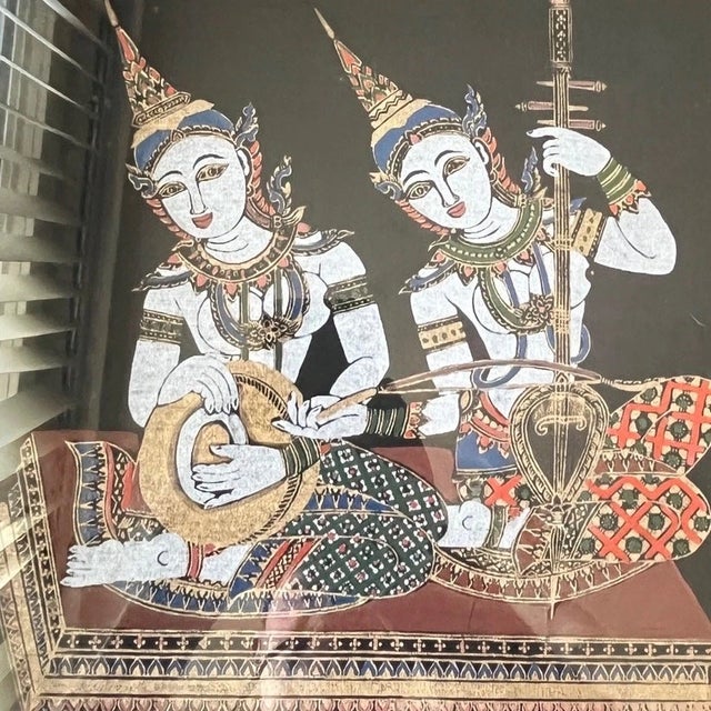 This stunning vintage Thai silk painting features two celestial musicians (Gandharvas) intricately hand-painted on black...