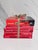 A collection of four red cover books, pre owned.