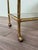 Trolley with faux bamboo brass structure and smoked glass tops. Made in Italy in the 70s It has four hard plastic wheels...