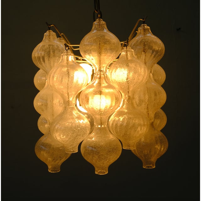 "Tulipan" 6-light chandelier in blown glass with teardrop-shaped blown glass elements. Suspended with metal fittings. Made...