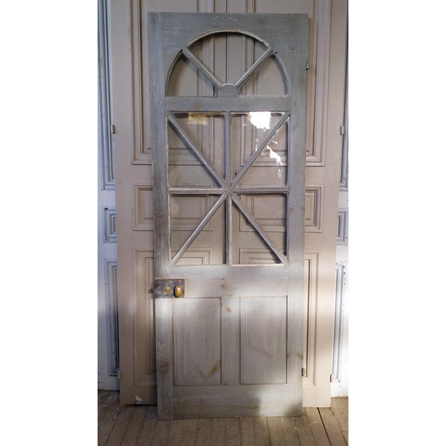 Elegant antique front door in good condition, preserved in its original state and boasting a beautiful patina. It features...