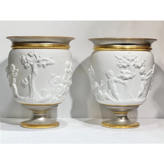 pair of antique Paris porcelain cachepots in the French Louis XV/XVI style measure 11 1/2 inches tall and 9 1/4 inches...