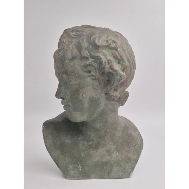 Sculpture / Bust of Eros - God of Love, in bronzed plaster. France, early 20th century. A copy of a bronze statue of Eros...