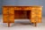 A distinctive mid-century writing desk from Czechoslovakia, featuring richly figured burl veneer, a symmetrical...