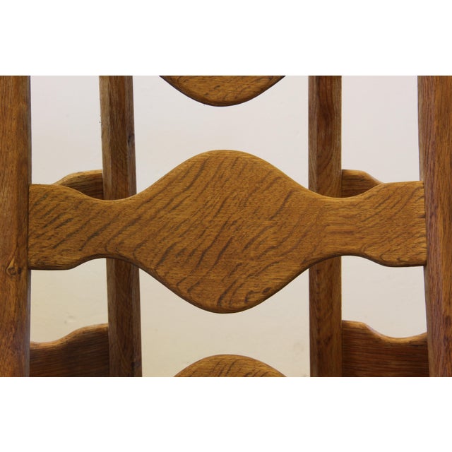 This set of six carved oak ladder-back chairs, familiar to the "Razorblade" model, designed by Henning Kjærnulf. Crafted...