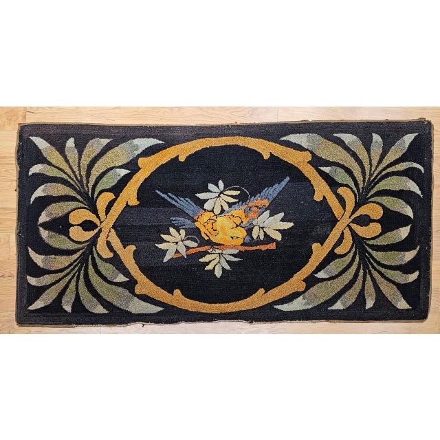 A charming example of early American textile artistry, this vintage hand-hooked pictorial rug features a stylized bird...