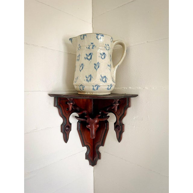 This handcarved corner shelf draws the eye in to appreciate both the bracket and the item displayed. Condition: Excellent...