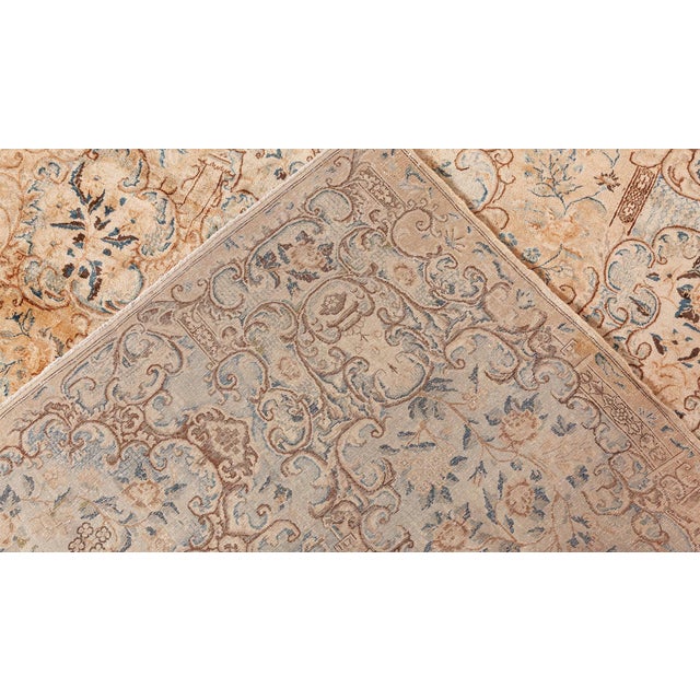 An unusual early 20th century Southeast Persian Kirman (Kerman) antique carpet, the pale peach field with elaborate...