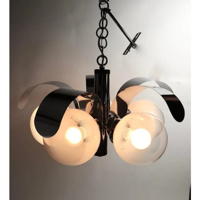 Chic and decorative mod midcentury chandelier having 5 art glass ball globe shades, each having an opaline white to clear...