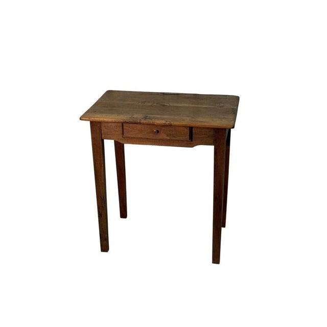 A 19th-century walnut coffee table, characterized by slender proportions and a simple yet charming structure. The piece...