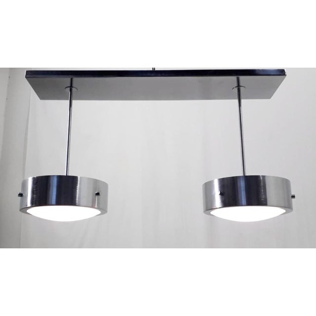 Italian modern flushmount with 2 glossy white Murano glass shades enclosed in double satin chrome finish border bands,...