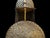 A domed helmet and a round shield rise together from a shared hammered stand, every surface raised entirely by hand into a...