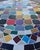 Beautiful round mosaic tile table featuring a vibrant multicolor tiled top and durable black wrought-iron style base. The...