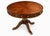 Handsome Theodore Alexander Regency-style mahogany drum table featuring a striking radial sunburst veneer top and...