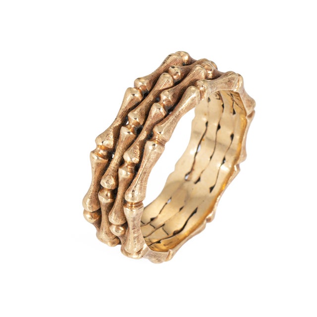 Stylish vintage bamboo ring crafted in 14k yellow gold (circa 1970s). The band highlights a textured bamboo design that...